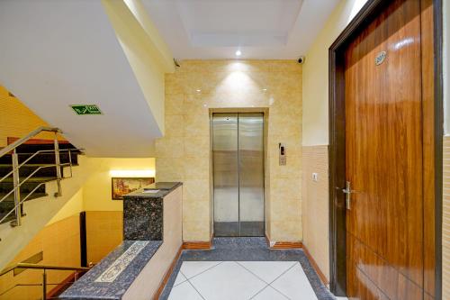 a hallway with a door and a staircase and a stair case at Hotel Le Grand - Walk-in from RK Ashram Metro Station in New Delhi