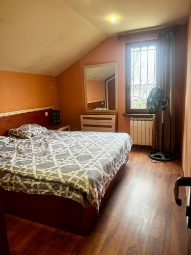 a bedroom with a bed and a large window at Armenia villa Jrvezh in Dzoraghpʼyur