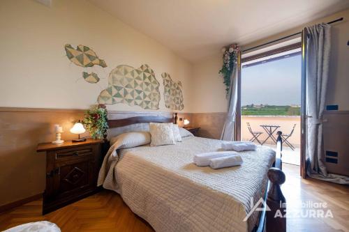 a bedroom with a bed with two towels on it at Villa i Roccoli - Immobiliare Azzurra in Bardolino