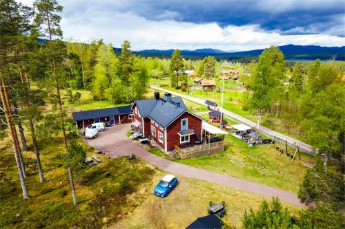 an aerial view of a red house with a garage at Gopshusgården - Rum & Stugor in Mora