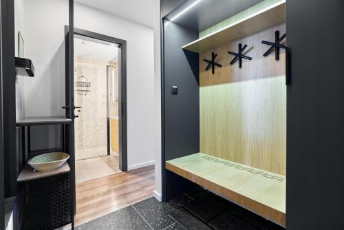 a bathroom with a glass door with a shelf at Kozlík, Kontryhel by Mountain ways in Abertamy