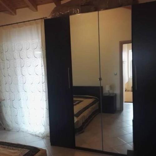 a bedroom with a bed and a glass wall at Traditional stone-built house with great view in Kondiás