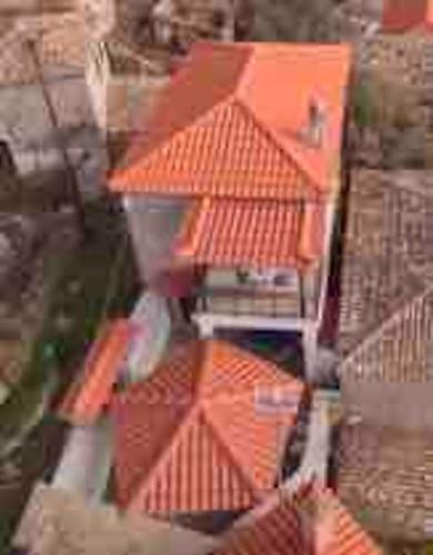 an aerial view of a building with an orange roof at Traditional stone-built house with great view in Kondiás