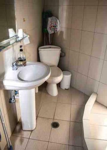 a small bathroom with a toilet and a sink at Traditional stone-built house with great view in Kondiás