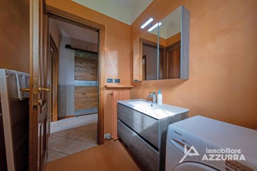 La salle de bains est pourvue d'un lavabo et d'un miroir. dans l'établissement Villa i Roccoli - Immobiliare Azzurra, à Bardolino