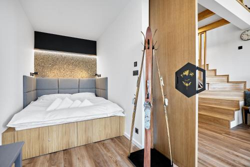 a bedroom with a bed and a staircase at Kozlík, Kontryhel by Mountain ways in Abertamy