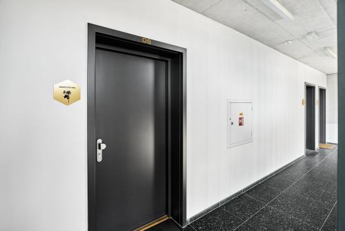 a black door in a room with white walls at Kozlík, Kontryhel by Mountain ways in Abertamy