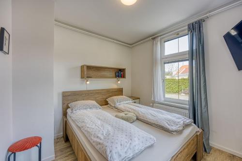 two beds in a room with a window at Apartments Jantar - Happy Rentals in Novo Mesto