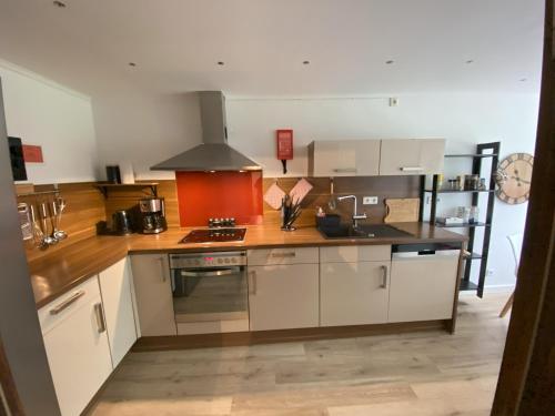 a kitchen with white cabinets and a stove top oven at Einzelzimmer Nr. 4 in Kleve in Kleve