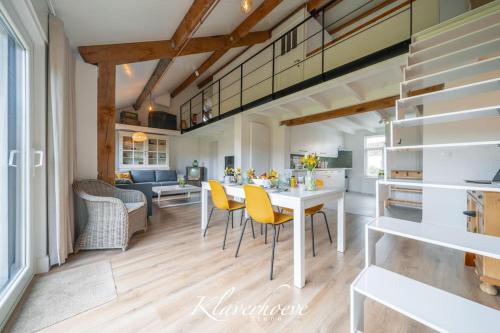 een keuken en een woonkamer met een tafel en stoelen bij Klaverhoeve Stene in Oostende