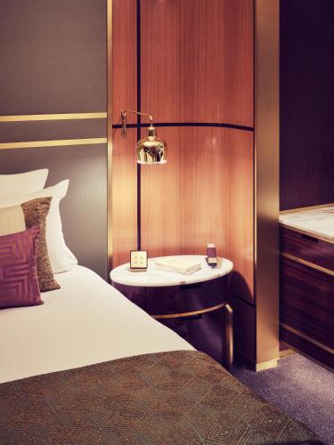 a hotel room with a bed and a table with a lamp at Royal Mansour Casablanca in Casablanca