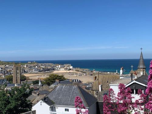 an aerial view of a town with the ocean at Cosy cottage between Penzance and St Ives in Gulval