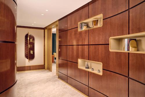 a hallway with wood paneled walls with shelves at Royal Mansour Casablanca in Casablanca