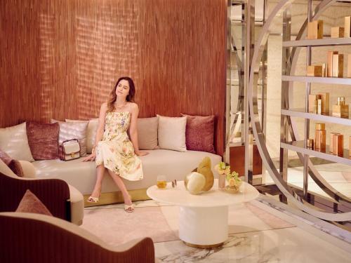 a woman standing on a couch in a living room at Royal Mansour Casablanca in Casablanca