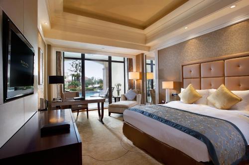 a hotel room with a large bed and a television at Hotel Shanghai Sheshan Oriental - Handwritten Collection in Songjiang