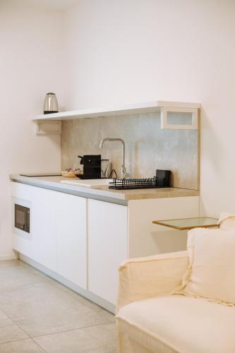 a kitchen with a sink and a counter at Marisabella Suite Spa 3 in Bari