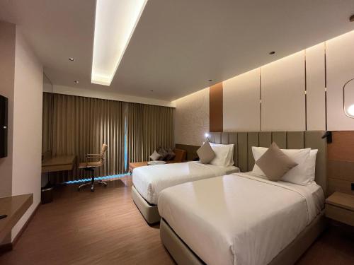 Letto o letti in una camera di Grand Madurai by GRT Hotels