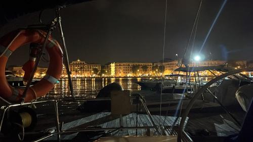a group of boats docked in a harbor at night at Charming sailing boat - Le dimore di Ines in Bari