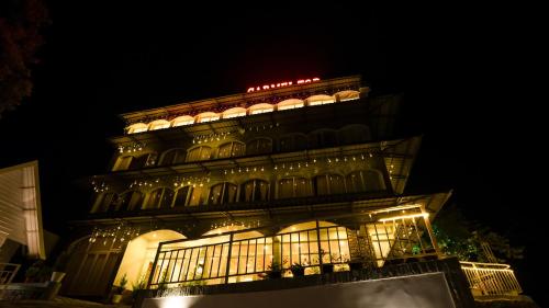 a building with lights on top of it at night at Carmel Top Munnar in Munnar