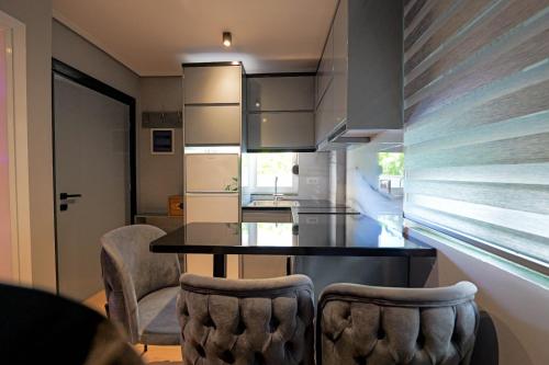 a kitchen with a dining room table and chairs at House Natalia in Sarandë