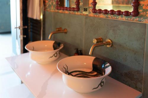 two sinks on a counter in a bathroom at The Tempus at Charlton Hall Estate in Alnwick
