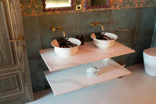 two sinks on a shelf in a bathroom at The Tempus at Charlton Hall Estate in Alnwick