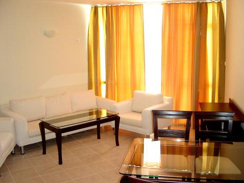 a living room with a couch and a table at Sun Palace Home Apartments in Sunny Beach