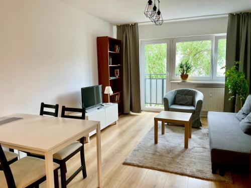 a living room with a table and a couch at Town Center Chmielna 116/118 in Warsaw