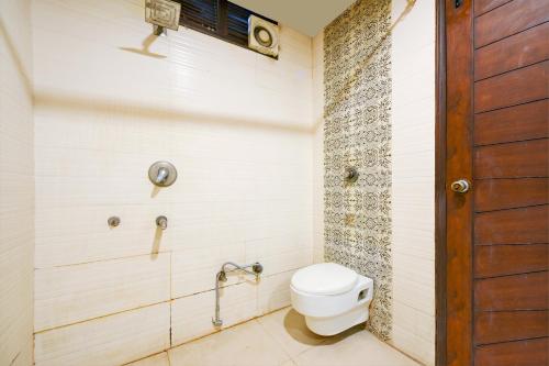 a bathroom with a toilet in a room at Hotel Raj - Walk-In from New Delhi Railway Station in New Delhi
