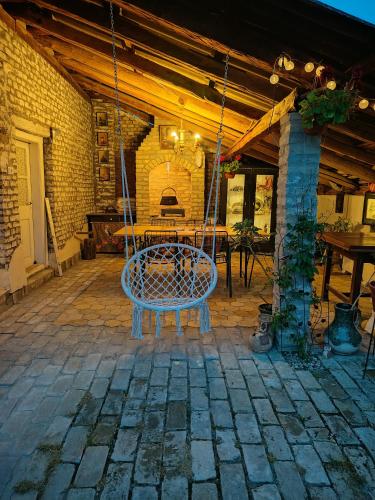 a swing in a patio with a table at Apartman Katarina Bački Monoštor in Bački Monoštor