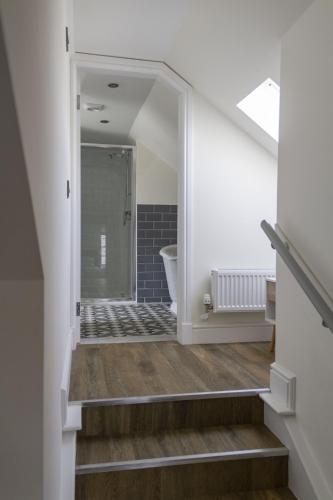 a bathroom with a stairs leading to a bath tub at Stroan in New Galloway
