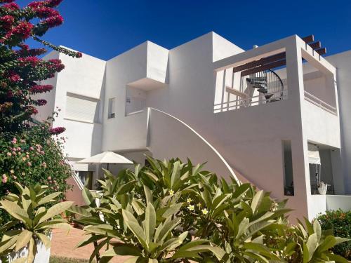 a white house with plants in front of it at Casa Bonica in Palomares