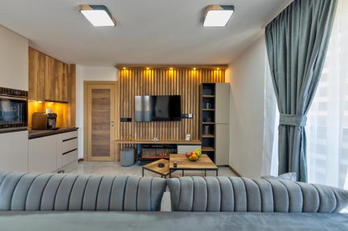 a living room with a couch and a table at Golden Panorama Spa & Wellness in Zlatibor