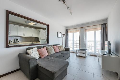 a living room with a couch and a television at GuestReady - Espinho Beach Flat in Espinho