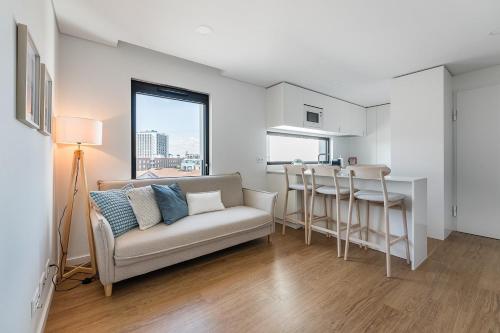 a living room with a couch and a table at GuestReady - A Slice of Aveiro in Aveiro