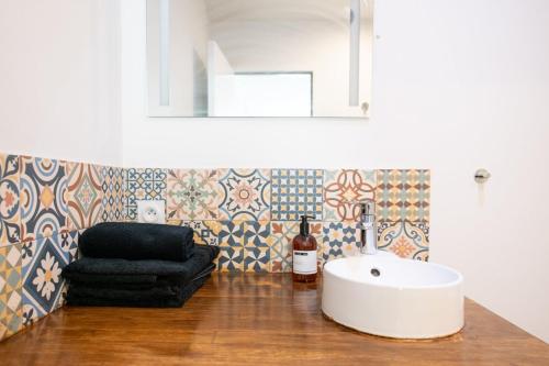 a bathroom with a sink and a chair at Central Part-Dieu - Appartement 1 in Lyon