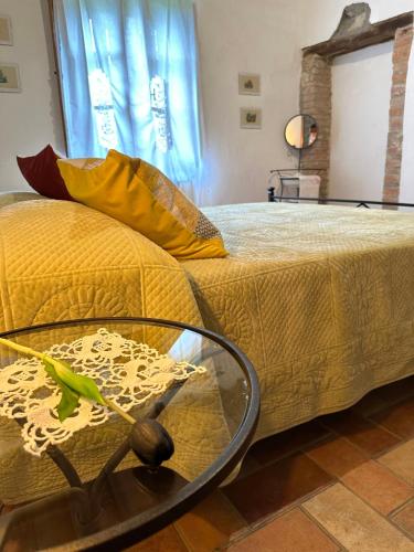 a bedroom with a bed with a glass bowl on it at Residence Lucignano in Lucignano