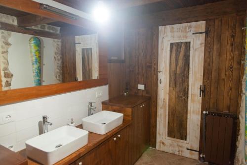 a bathroom with two sinks and a mirror at Il Palazz8 - Dimore di Charme in San Polo dei Cavalieri