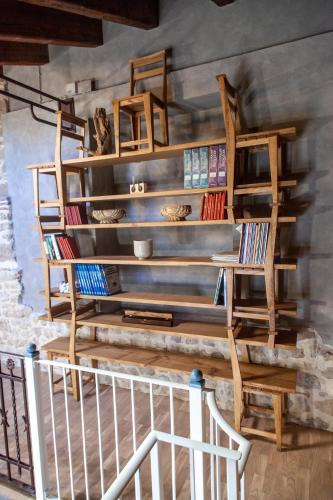 a room with a staircase with wooden bookshelves at Il Palazz8 - Dimore di Charme in San Polo dei Cavalieri