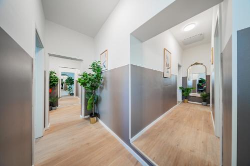 an empty hallway with potted plants on the wall at SEVEN Rooms Vienna in Vienna