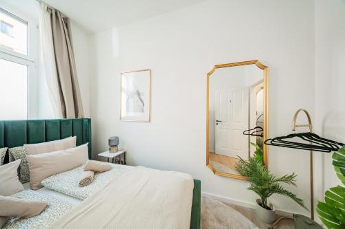 a bedroom with a bed and a mirror at SEVEN Rooms Vienna in Vienna