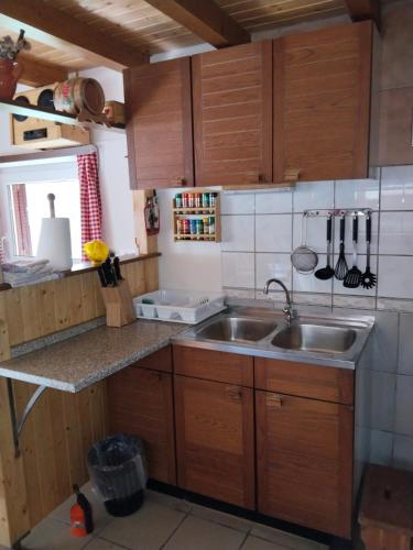 a kitchen with wooden cabinets and a sink at Wooden Treasure in Jesenice