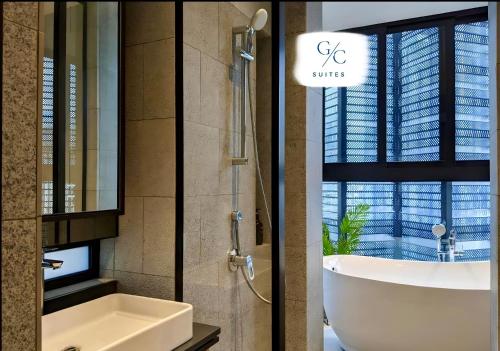 a bathroom with a tub and a sink and a shower at Scarletz KLCC luxury suites by GC-Suites in Kuala Lumpur