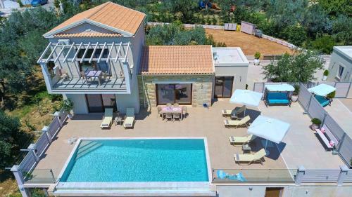 an aerial view of a house with a swimming pool at Lefkimmiatis Villas Corfu in Afionas