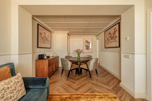 a living room with a table and chairs at Only YOU Hotel Sevilla in Seville