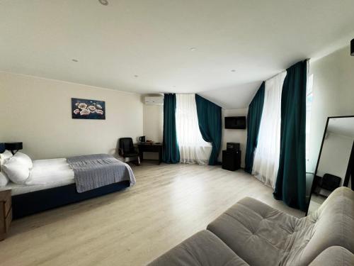 a bedroom with a bed and a couch in a room at SIGNEEV'S Villa in Kyiv