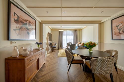 a living room with a table and a dining room at Only YOU Hotel Sevilla in Seville