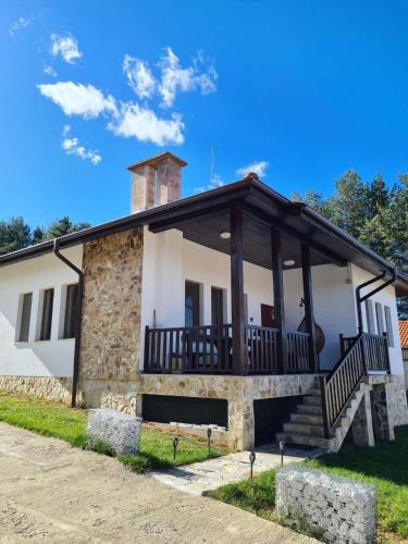 a stone house with a porch and stairs at Вила Мариам Villa Mariam in Batak