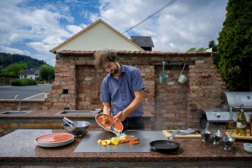 a man standing on a counter preparing food at Hotel-Restaurant Laux in Merzig