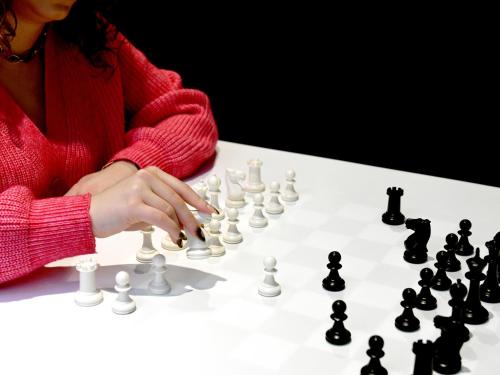 a woman playing a game of chess at Mercure Arras Centre Gare in Arras